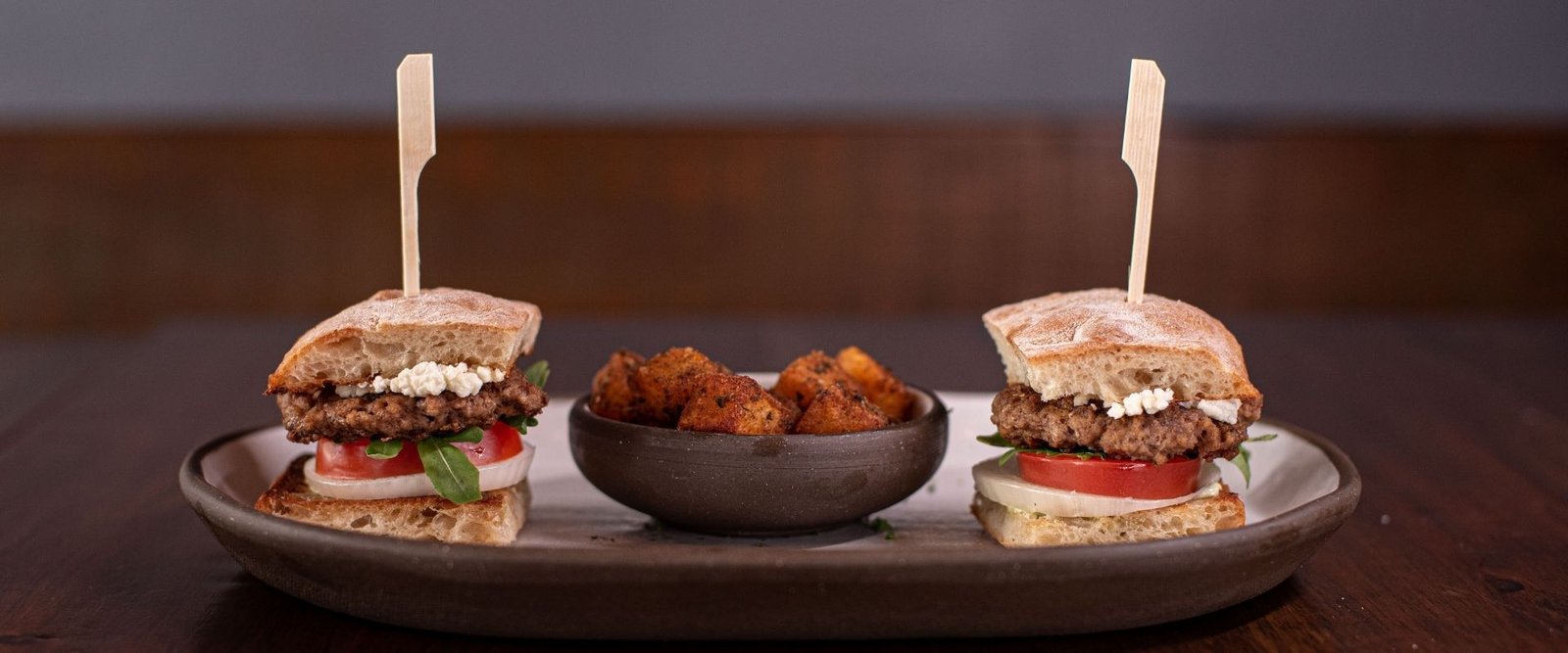 Lamb Sliders Goat Cheese, Arugula, Tomato, Onion, Cucumber Aioli, Ciabatta Bread and Served with Herbed Potatoes at Red Cork Bistro in Mukilteo Lamb Sliders Goat Cheese, Arugula, Tomato, Onion, Cucumber Aioli, Ciabatta Bread and Served with Herbed Potatoes at Red Cork Bistro in Mukilteo