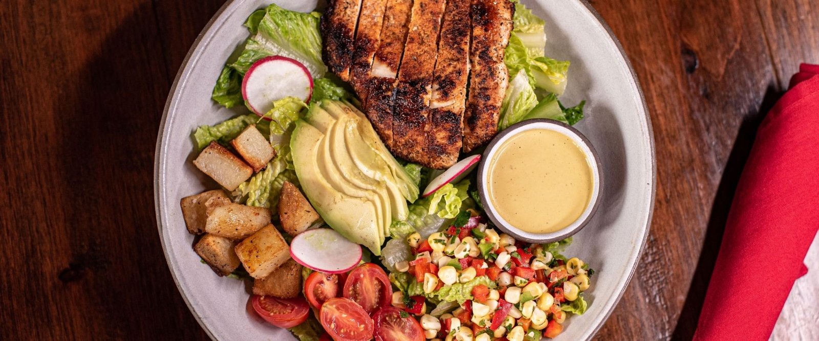 Blackened Chicken Salad with Romaine, Corn Pico, Tomato, Roasted Potatoes, Avocado, Jalapeño Cilantro Dressing (Gluten Free) at Red Cork Bistro in Mukilteo Blackened Chicken Salad with Romaine, Corn Pico, Tomato, Roasted Potatoes, Avocado, Jalapeño Cilantro Dressing (Gluten Free) at Red Cork Bistro in Mukilteo