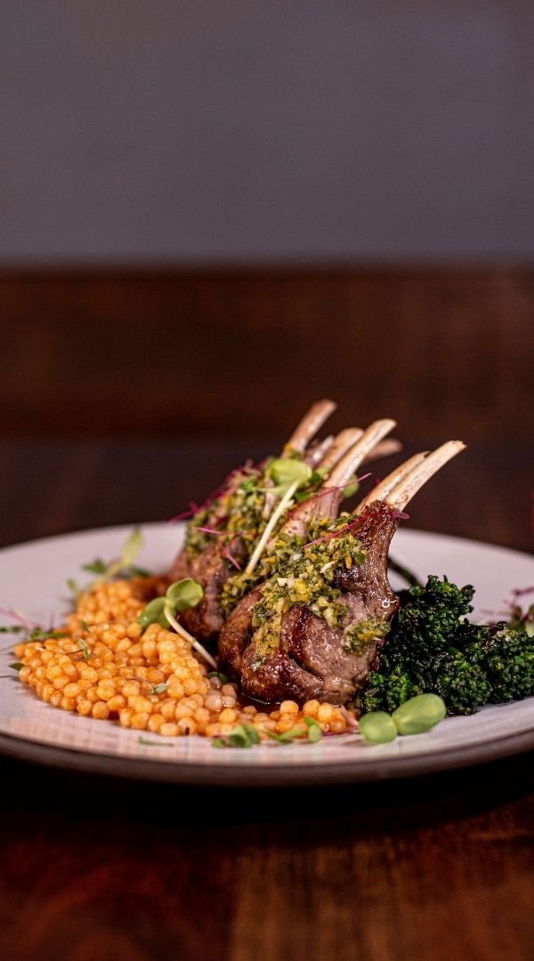 Rack of Lamb with Citrus Chimichurri, Roasted Red Pepper Couscous, and Broccolini at Red Cork Bistro in Mukilteo